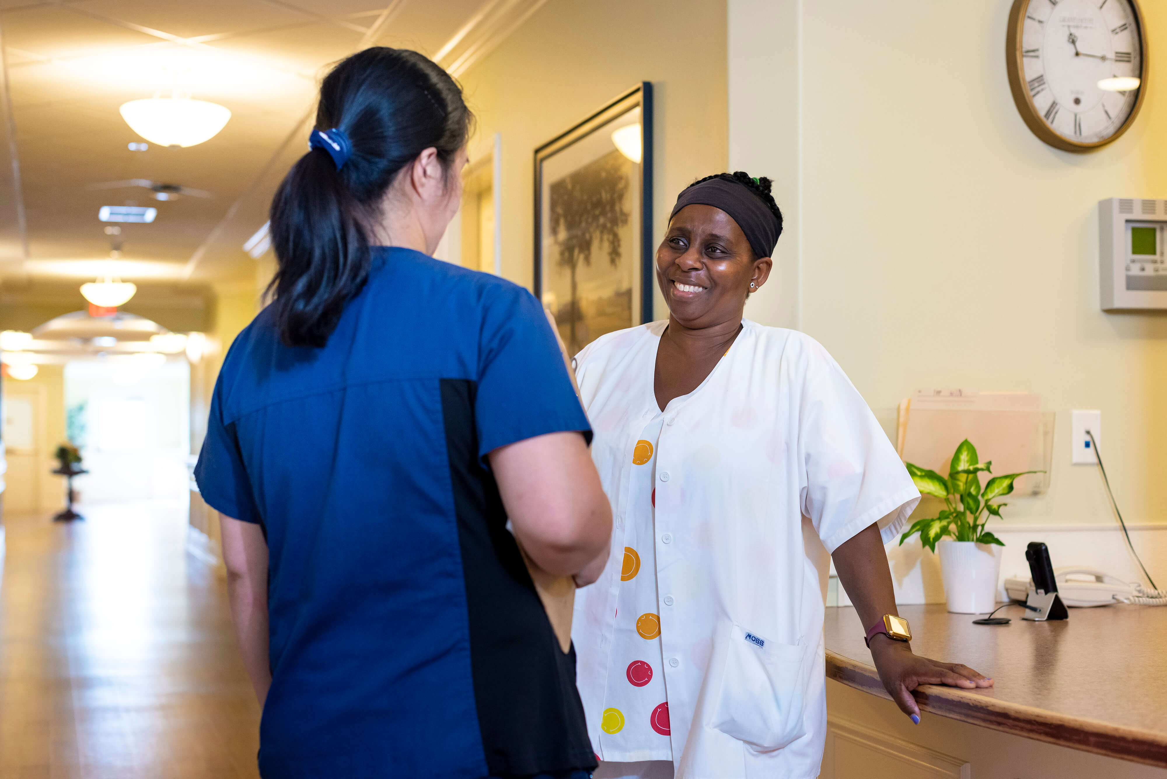 Parkland retirement nurses wearing scrubs engaging in workplace duscussion