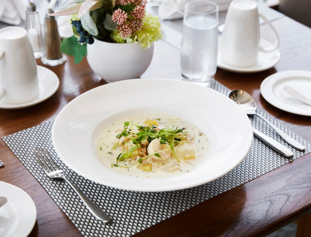 Plate set with seafood chowder.