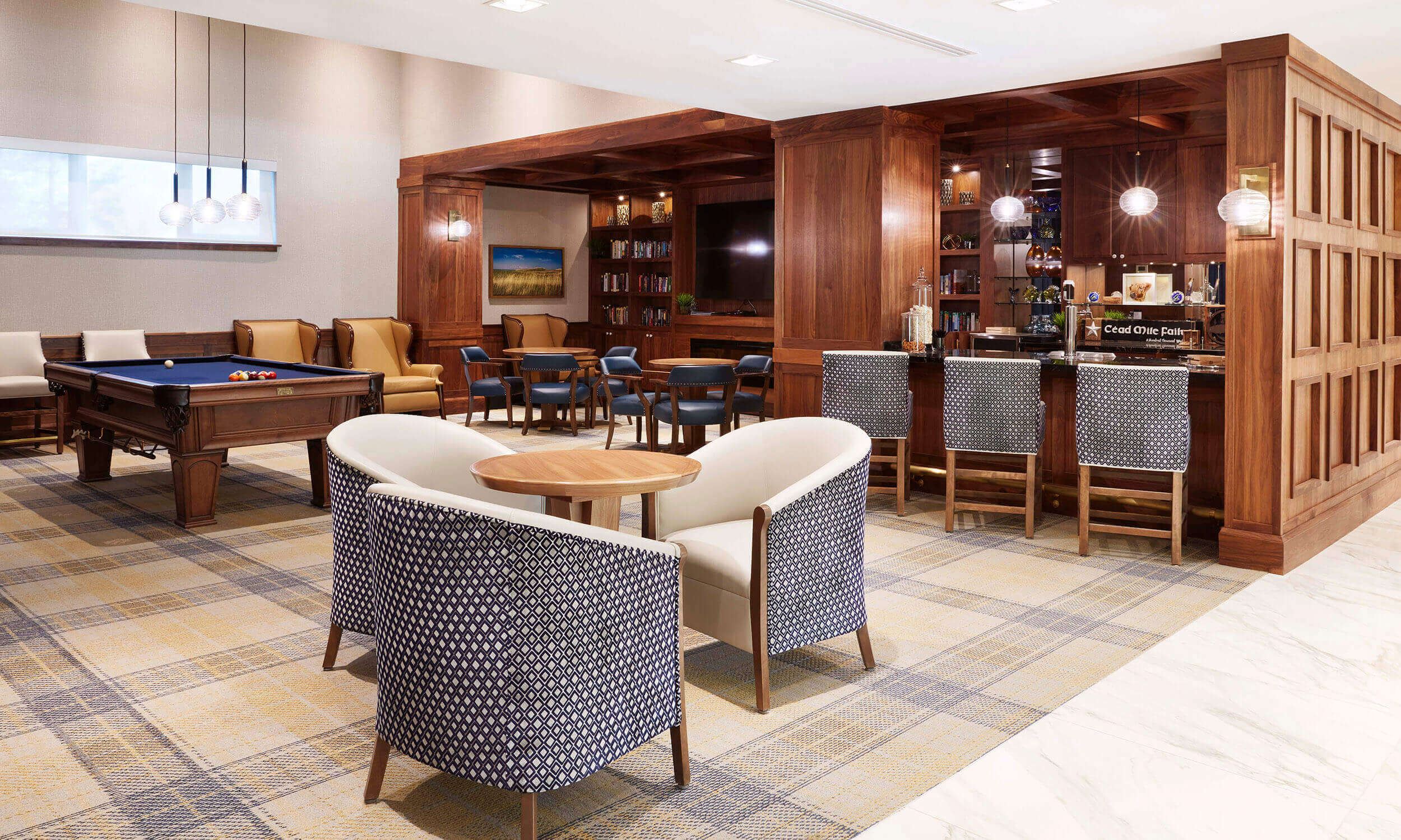 A photo of a Bar, with seating and a pool table in the back