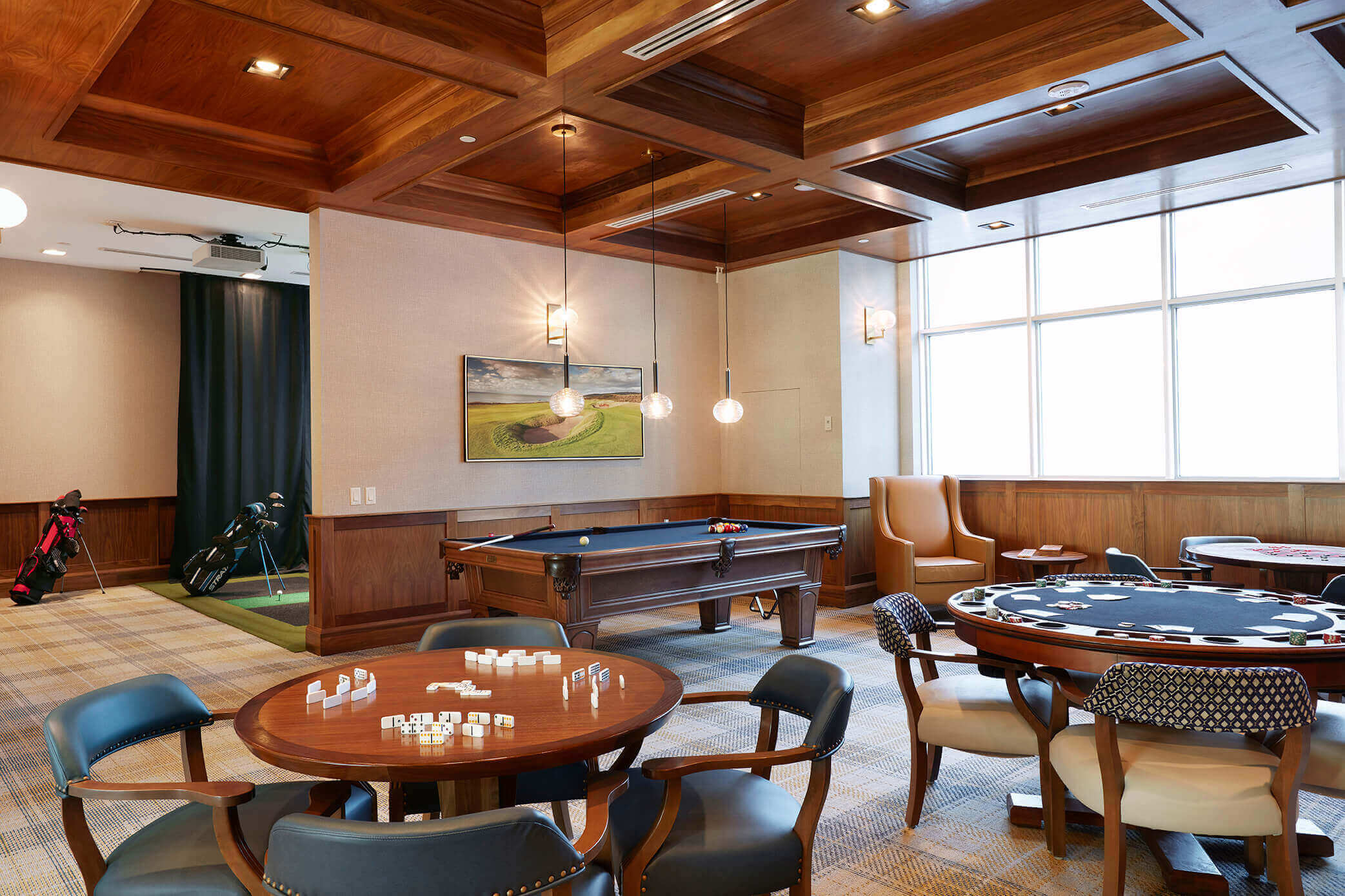 Games Room with two poker tables and a pool table behind them.