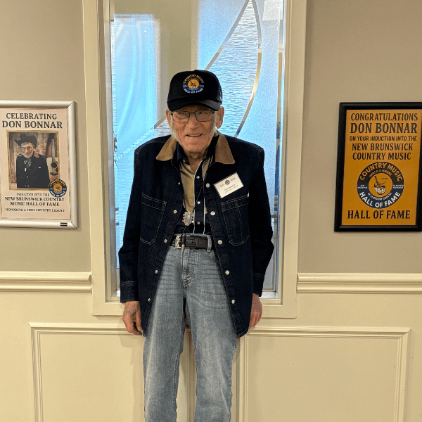 Photo of an older adult with frame awards